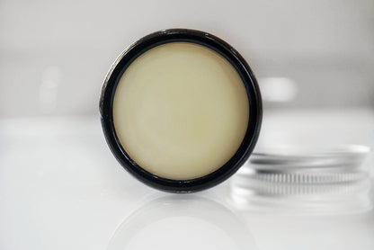A amber 2 0z glass jar of the best all natural handmade styling beard balm from grzzly beard co